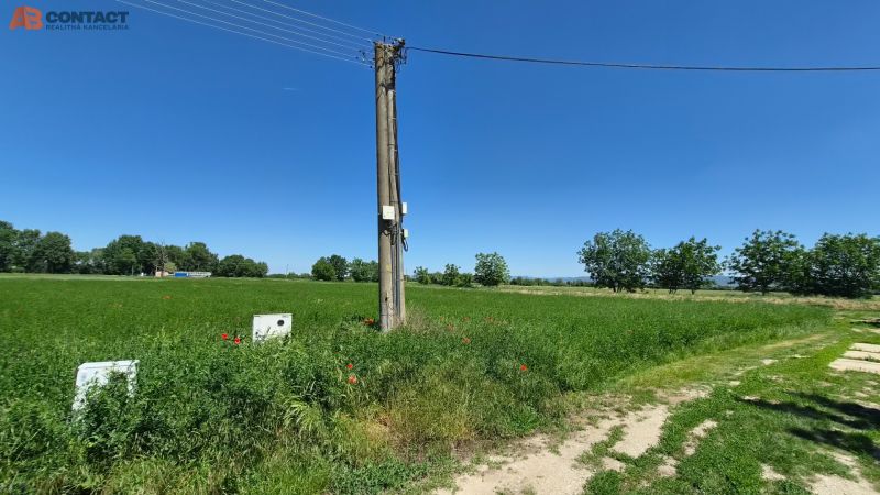 Stavebný pozemok v pokojnej časti obce Veselé - Trávnatý pozemok s elektrickým stĺpom na ulici Veselé v meste Veselé. Pozemky - bývanie.