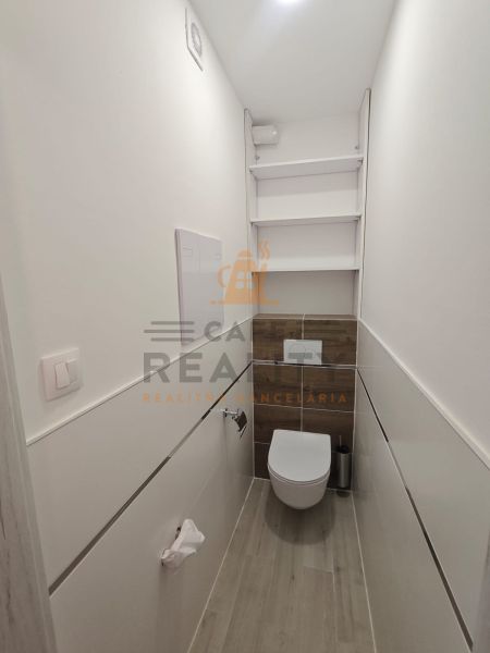 Na prenájom 1 izbový byt, 34 m2, Bratislava, Petržalka, Lachova ulica - Útulná kúpeľňa s podlahou s dreveným dekorom v 1-izbovom byte.