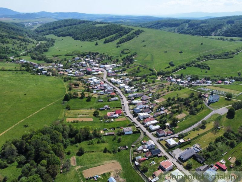 Slnečný stavebný pozemok 1 186 m² - Karná | možnosť dokúpiť 1 ha - Letecký pohľad na obec Karná obklopenú kopcami a pozemkami na bývanie.