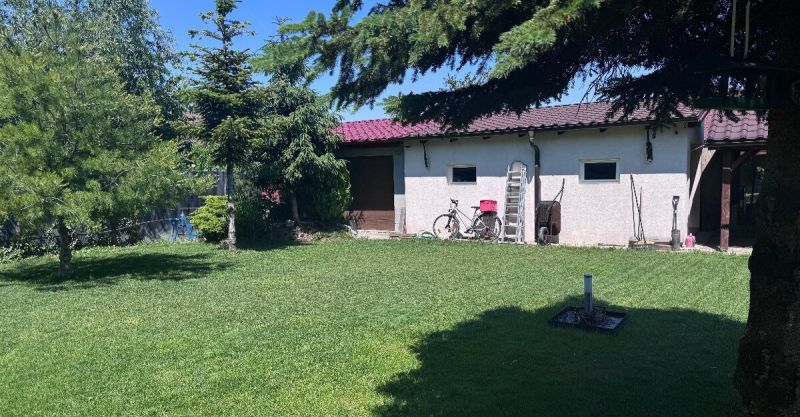 Rodinný dom v Dunajskej Lužnej  - Záhrada rodinného domu na Nových Košariskách v Dunajskej Lužnej, s garážou a bicyklom.