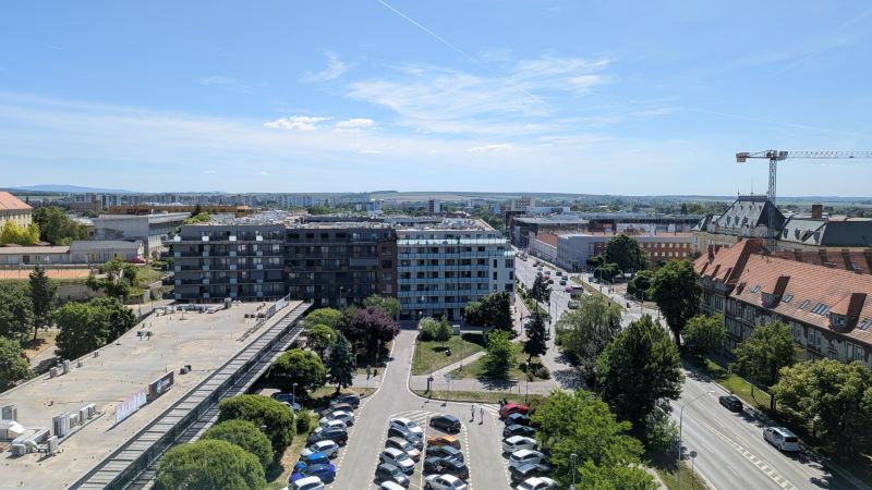 3 izbový byt v centre mesta na Štúrovej ulici s krásnym výhľadom - Pohľad na Štúrovu ulicu v Nitre s bytovými domami a parkoviskom.