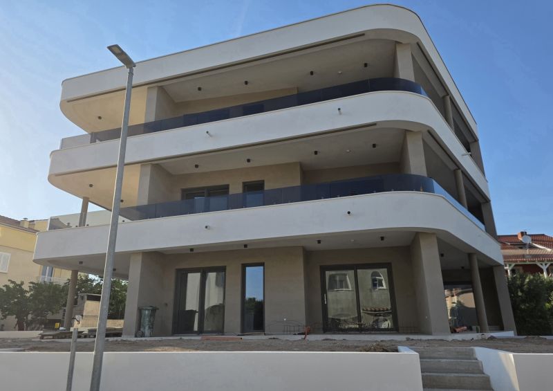 CHORVÁTSKO - Apartmány 140 m od pláže (3i) - VODICE - Bytový dom v meste Vodice ukazuje architektúru s priestrannými balkónmi.