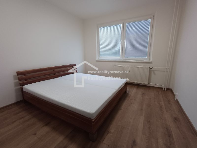 Krásny 3 izbový byt na prenájom. - Spálňa s posteľou a podlahou s dreveným dekorom v 3-izbovom byte.