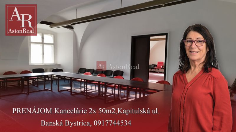 PRENÁJOM: Kancelárie 2x 50m2, Kapitulská ul.Banská Bystrica - Žena v kancelárii s plochým stolom, stoličkami a oblúkovou architektúrou v Banskej Bystrici.