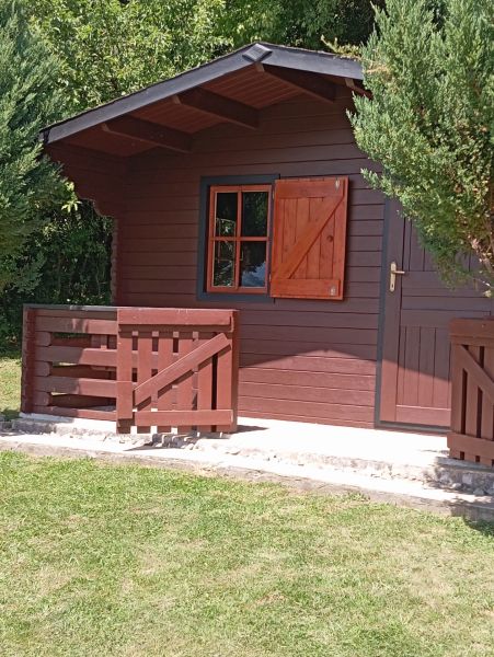 TURANY- rekreačná chata na pozemku 700m2 - Drevená chata so záhradkou na ulici Černík, obklopená zeleňou a trávnikom.