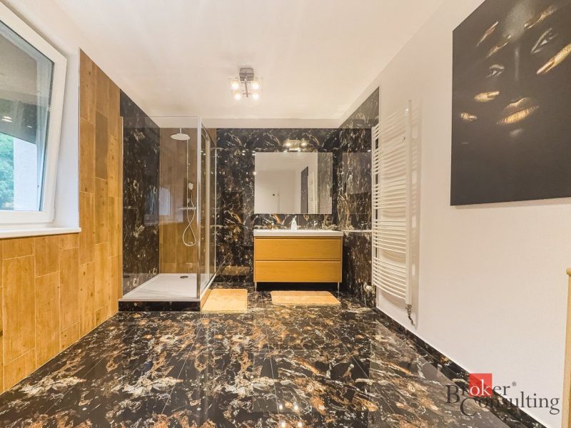 Zariadený 1i apartmán s balkónom na Hradnom kopci - Kúpeľňa v 1-izbovom byte s mramorovou dlažbou a sprchovacím kútom.