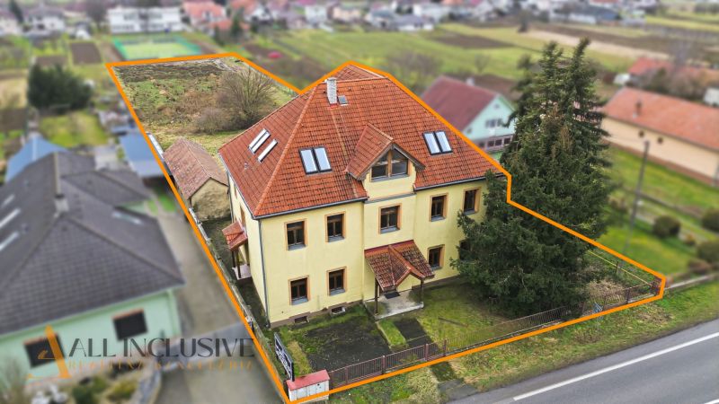  POLYFUNKČNÝ OBJEKT | CHRABRANY | TOPOĽČANY - Budova na ulici Chrabrany v Topoľčanoch, obklopená záhradou a cestou.