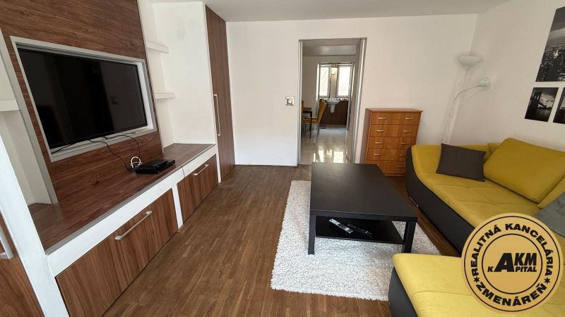 1 izbový 30m2 slnečný byt Zvolen centrum na PRENÁJOM ul. Študentská - Obývacia izba s podlahou s dreveným dekorom a pohodlnou sedacou súpravou v 1-izbovom byte.