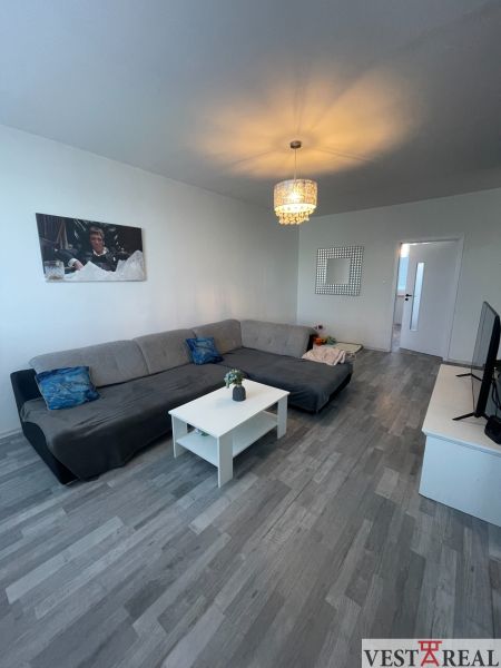 VESTAREAL | Na predaj priestranný 3-izbový byt s balkónom Galanta - Obývacia izba s pohovkou, konferenčným stolíkom a podlahou s dreveným dekorom v 3-izbovom byte.