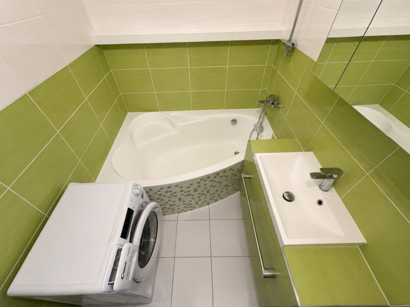 Na prenájom 3 izbový byt - Banská Bystrica, Starohorská ulica - Kúpeľňa so zelenými obkladačkami, vaňou a práčkou v 3-izbovom byte.
