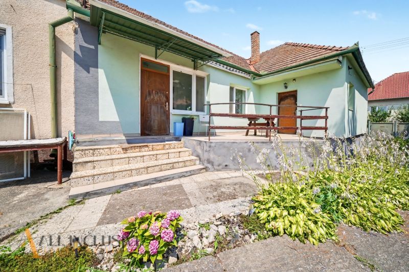 Na predaj 5-izb.rd vhodný na dvojgen. býv., Topoľníky - Rodinný dom v Topoľníkoch s terasou, záhradou a drevenými dverami.