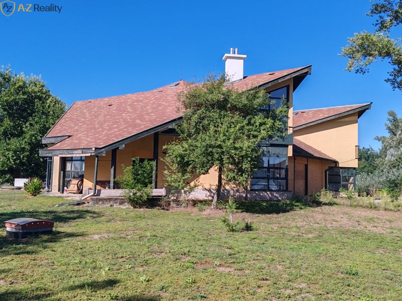 Komerčný objekt na predaj v Chotíne - Budova v Komárne s modernou architektúrou, obklopená zeleňou a modrou oblohou.