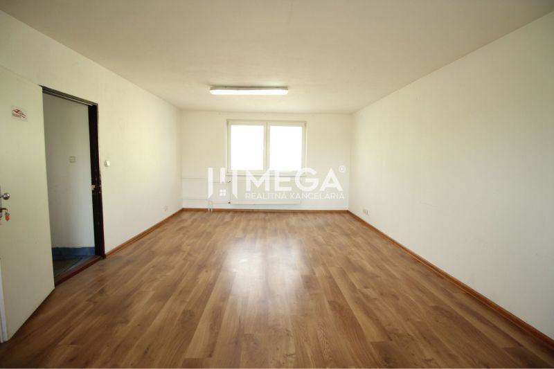 PRENÁJOM KANCELÁRII 40 m² BEZ DEPOZITU - Chemlonská HUMENNÉ - Priestranná kancelária s podlahou s dreveným dekorom a bielymi stenami.