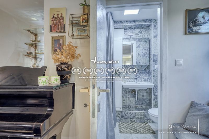Dom v jednej z najkrajších častí Devína s unikátnym výhľadom - Interiér chaty s klavírom, dekoráciami a kúpeľňou s mozaikovými obkladmi.