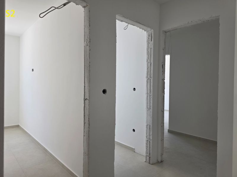 CHORVÁTSKO - Moderné apartmány 80 m od mora - SRIMA, VODICE - Chodba v 3-izbovom byte s bielymi stenami a svetlou podlahou.