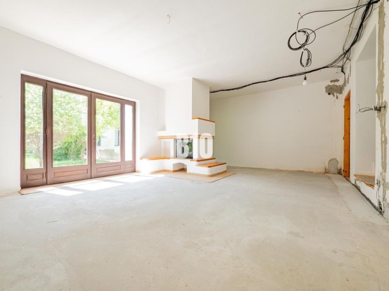 REZERVOVANÉ_RD v Nitre, Veľké Janíkovce – 994 m2 pozemok - Rodinný dom s veľkými oknami a krbom, čakajúci na dokončenie interiéru.
