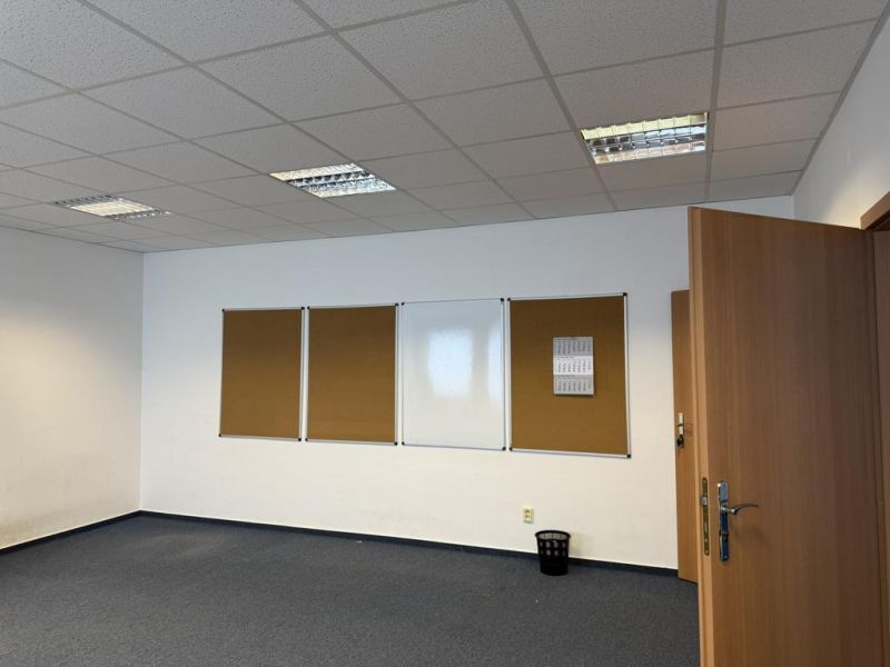 Kancelárske, obchodné a skladové priestory od 14m2 do 500m2 v areáli. - Kancelária s bielou tabuľou, textilnými nástenkami a modrým kobercom, Sklady a haly.