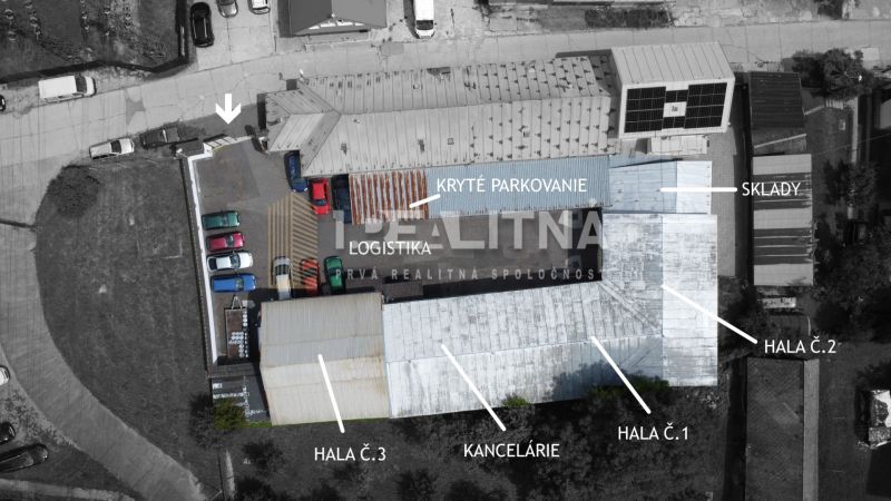Priemyselný areál (tri haly, recepcia, kancelária, garáže, logistika) - Letecký pohľad na logistické sklady a haly v Banskej Bystrici s parkovaním.