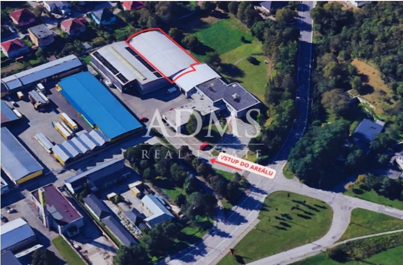Skladová hala - Letecký pohľad na sklady a haly v Žiline obklopené zeleňou a budovami.