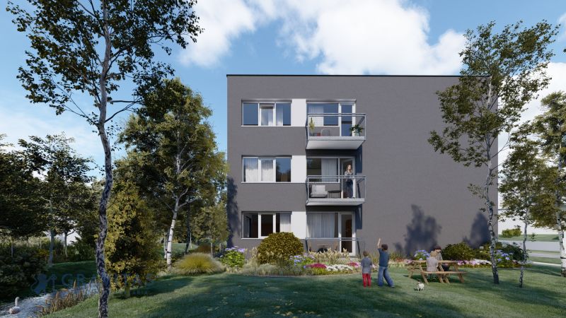 Pozemok s rozostavanou stavbou pre 12 bytov - Senica - Bytová budova s balkónmi obklopená stromami, trávnikom a ľuďmi v záhrade.