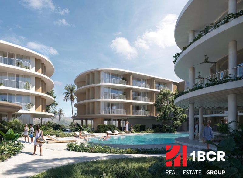 THE CORAL KOH SAMUI - Výstavba bytov v Surat Thani so zaoblenými budovami a bazénom uprostred komplexu.