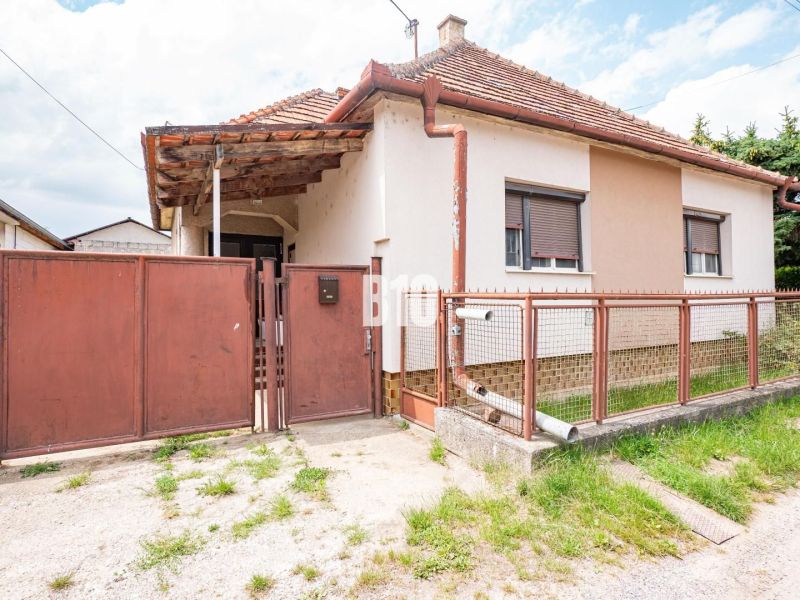DOM, 1439 m2 pozemkom - Zbehy, Nitra (investičný potenciál) - Rodinný dom v Nitre s plechovým plotom a šikmou strechou.