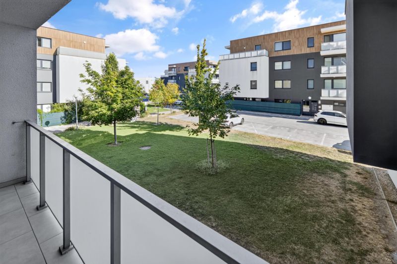 Predaj 2-izbový byt GREEN VILLAGE, loggia, parkovanie, Dunajská Lužná - Balkón 2-izbového bytu na Orechovej ulici v Dunajskej Lužnej s výhľadom na parkovacie miesta.