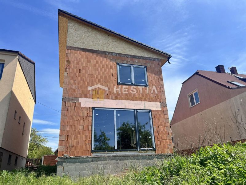 Novostavba podľa Vašich predstáv !! - Rodinný dom v Cerovej s nedokončenou tehlovou fasádou a veľkými presklenými dverami.