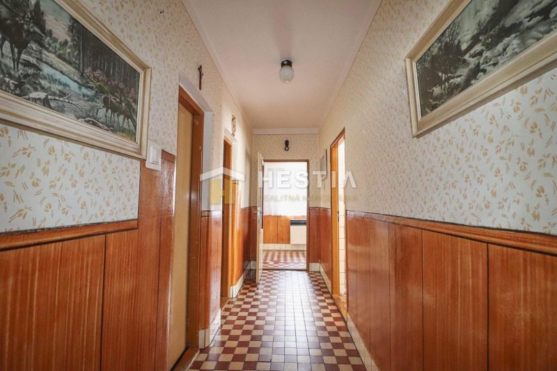 Rodinný dom Borský Mikuláš - Chodba v rodinnom dome s povrchmi z dreveného dekoru a vzorovanou podlahou.