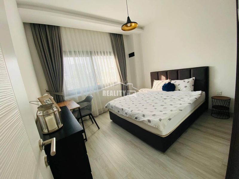 MODERNÁ VILA 3+1 S VÝHĽADOM NA MORE A HORY | YENİ BOĞAZİÇİ, - Spálňa s posteľou, písacím stolom a podlahou s dreveným dekorom v rodinnom dome.