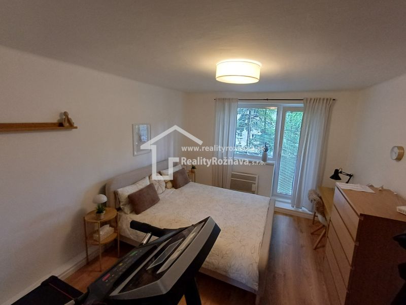 Krásny 2 izbový byt s balkónom- Vargové pole. - Spálňa v 2-izbovom byte s podlahou s dreveným dekorom a tréningovým zariadením.