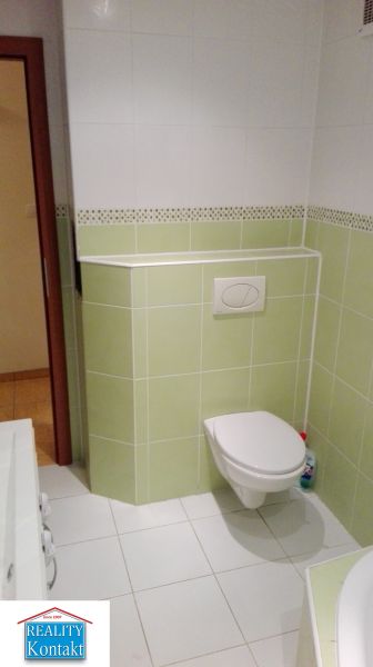 Na prenájom 3-izbový byt so záhradkou v Nových Zámkoch - Kúpeľňa s bielymi a zelenými obkladačkami v 3-izbovom byte, WC a umývadlo.