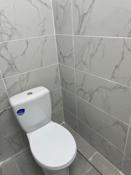 Ponúkame obchodné priestory 800m2 - Toaleta s mramorovým obkladom v Obchodných priestoroch, šedá podlaha.