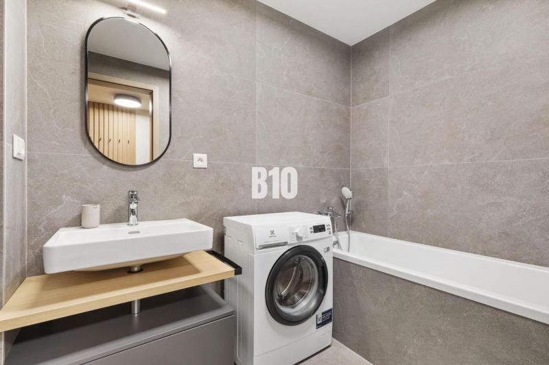 DOWNTOWN NA DOSAH – DIZAJNOVÝ 1-izbový apartmán s loggiou a výhľadom n - Kúpeľňa s umývadlom, práčkou a vaňou v 1-izbovom byte.