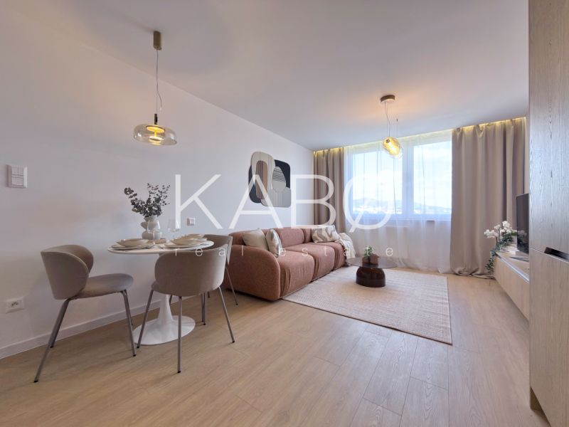 Moderný 3 izbový byt s balkónom a výhľadom na Zobor - Chrenová - Obývacia izba s pohovkou, jedálenským stolom a podlahou s dreveným dekorom v 3-izbovom byte.