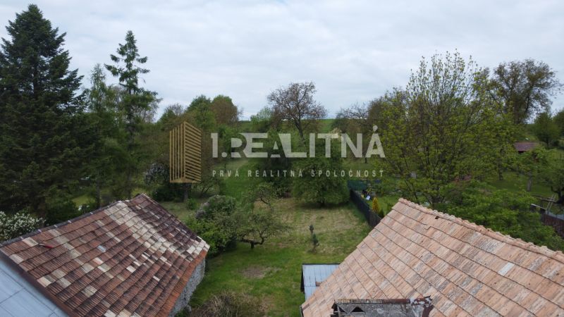 RODINNÝ DOM NA  REKONŠTRUKCIU PODĽA VLASTNÝCH PREDSTÁV, PONIKY, 1157M2 - Záhrada pri rodinnom dome na Družstevnej ulici v Ponikách, obklopená stromami a zeleňou.