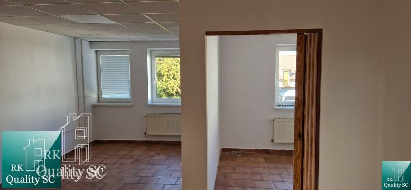 NA PREDAJ – polyfunkčný objekt v úplnom centre mesta Senec - obchodný  - Obchodné priestory s oknami, dlažbou a bielymi stenami, dva vykurovacie radiátory.