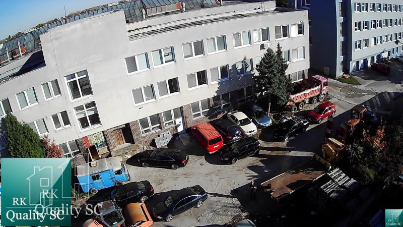 BRATISLAVA III. - RAČA - NA PREDAJ - priemyselný objekt s polyfunkčnou - Výrobné priestory na Staviteľskej ulici v Bratislave III s parkoviskom a zaparkovanými autami.