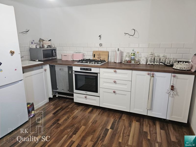 Senec - EXKLUZÍVNE NA PREDAJ - 4 izbový RD v blízkosti Slnečných jazie - Kuchyňa v rodinnom dome s bielymi skrinkami a podlahou s dreveným dekorom.