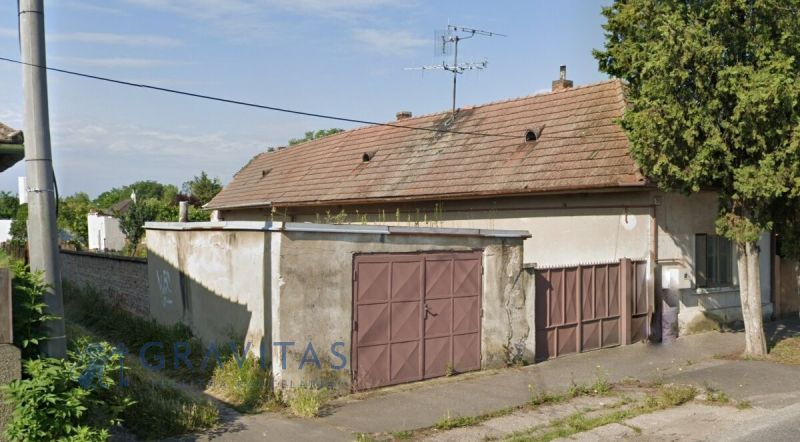 Na predaj investičný pozemok s domom - Rodinný dom v obci Reca s tradičnou strechou a garážou.