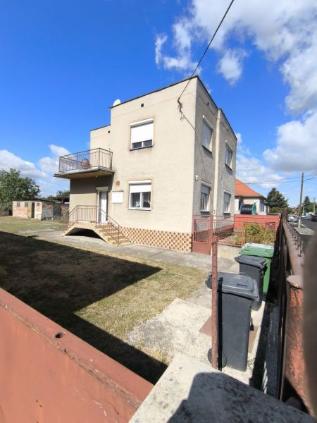 EXKLUZÍVNE LEN U NÁS! 4-izbový rodinný dom v obci Vydrany - Rodinný dom vo Vyadranoch s balkónom, trávnikom a modrou oblohou v pozadí.