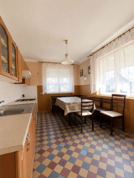 EXKLUZÍVNE LEN U NÁS! 4-izbový rodinný dom v obci Vydrany - Kuchyňa v rodinnom dome s károvanou podlahou, stolom a stoličkami pri okne.