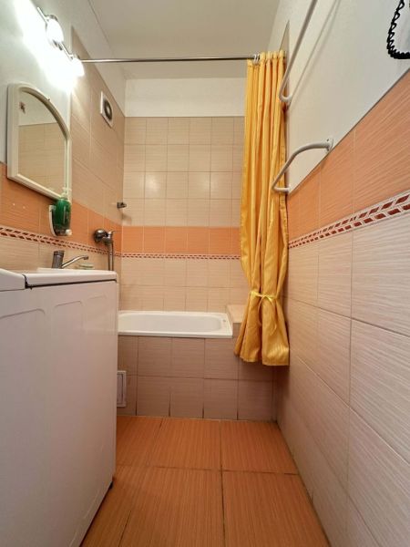 REZERVOVANÉ   NOVÁ CENA !!!!  108000,-EUR  NA PREDAJ EXKLUZÍVNE  : 1  - Kúpeľňa s vaňou a práčkou v 1-izbovom byte s oranžovým obkladom.