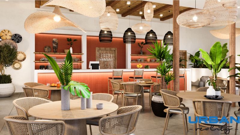 Hotelový a rezidenčný komplex THE TERRACE v Paje, Zanzibar - Interiér s dreveným dekorom, prútenými stoličkami a rastlinami v rámci výstavby bytov.