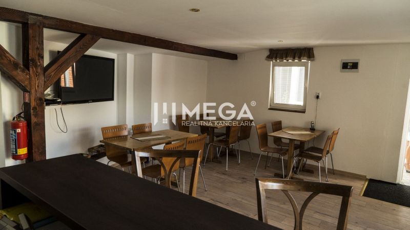 Na predaj nehnuteľnosť - zabehnutý penzión v centre mesta Humenné - Interiér s drevenými trámami, stolmi a stoličkami v priestoroch pre hostí Hotely a penzióny.