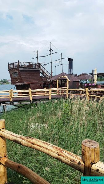 Chatka na vode v prekrásnom prostredí Seneckých jazier - Drevená loď ako atrakcia pri chate na Seneckých jazerách, za dreveným plotom.