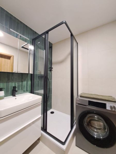 Prenájom kompletne zrekonštruovaného 2-izbového bytu s balkónom - Kúpeľňa 2-izbového bytu s moderným sprchovacím kútom, práčkou a zeleným obkladom.