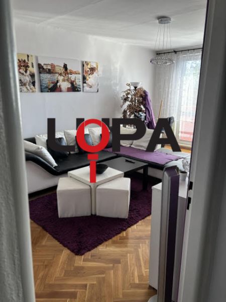 PREDAJ  2 izb. bytu s balkónom v Komárne - Pohodlná obývačka s podlahou s dreveným dekorom vo vyhľadávanom 2-izbovom byte.