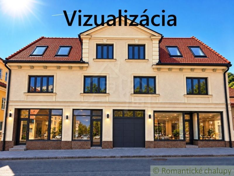 Multifunkčná budova v srdci Modrého Kameňa v okrese Veľký Krtíš - Fasáda budovy s obchodnými priestormi v meste Modrý Kameň, zachytávajúca presklené výklady.